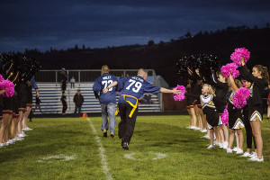Senior Trooper Scott Rector takes time to high five a young cheerleader as he is introduced to the crowd. 