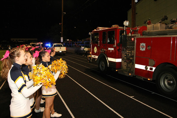 In this photo the Hood River Cheerleaders help welcome in the families riding in the procession